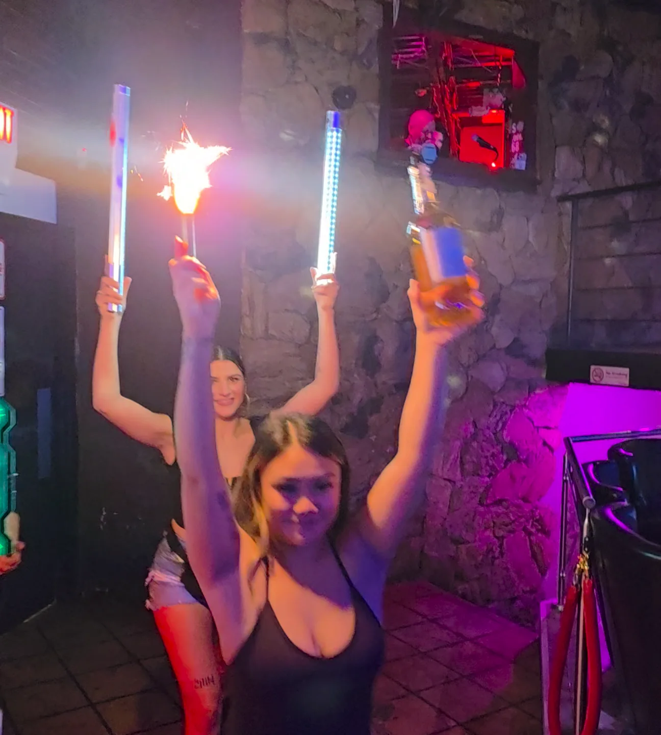 The Whiskey bottle-service team carrying illuminated bottles and sparklers.